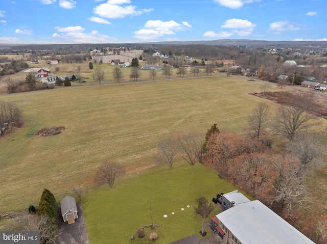 birds eye view of property with a rural view