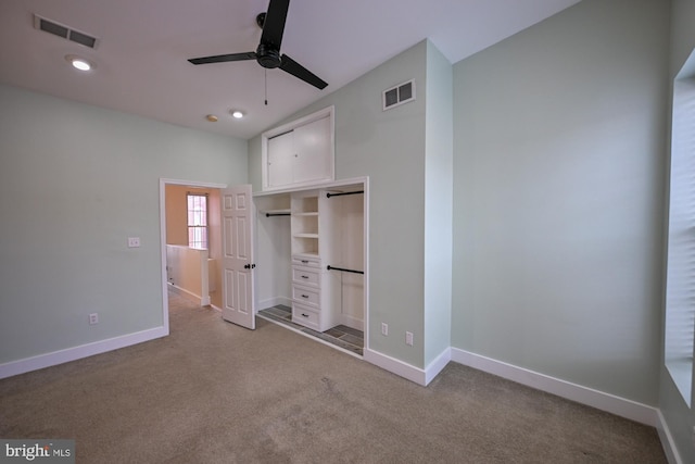 unfurnished bedroom featuring carpet, ceiling fan, and a closet