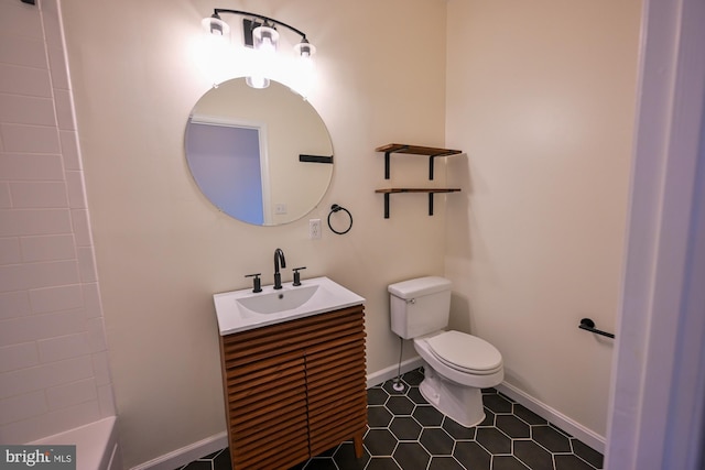 bathroom featuring tile patterned flooring, vanity, and toilet