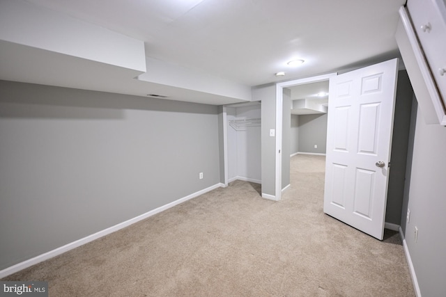 basement featuring light colored carpet