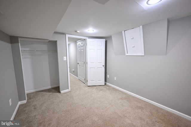 unfurnished bedroom featuring light carpet and a closet