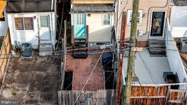 rear view of property featuring central AC unit