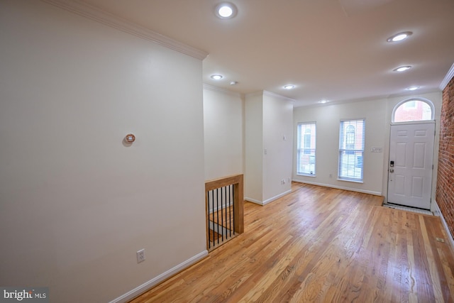 foyer entrance featuring light hardwood / wood-style floors and ornamental molding