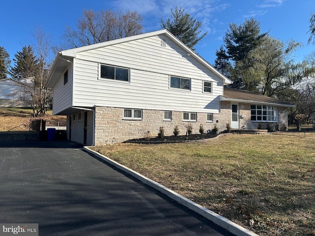 view of home's exterior featuring a yard and a carport