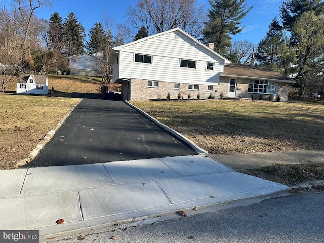 view of home's exterior featuring a garage and a yard