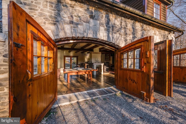 interior space featuring lofted ceiling with beams and dark colored carpet