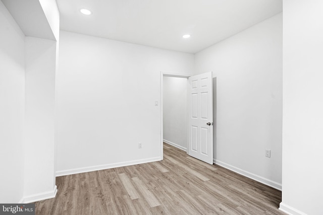 unfurnished room with light wood-type flooring