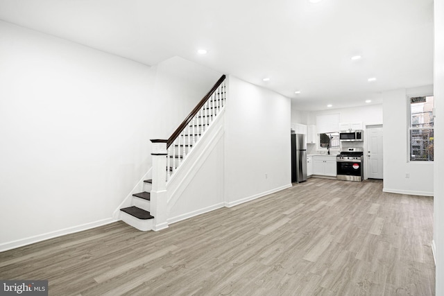 unfurnished living room featuring light hardwood / wood-style floors