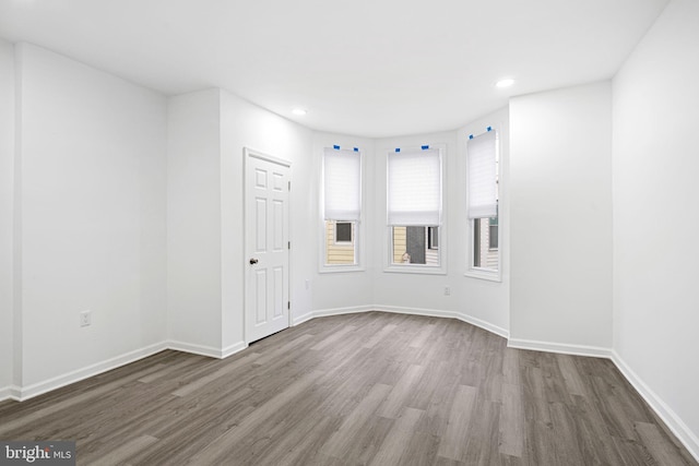 spare room with hardwood / wood-style floors