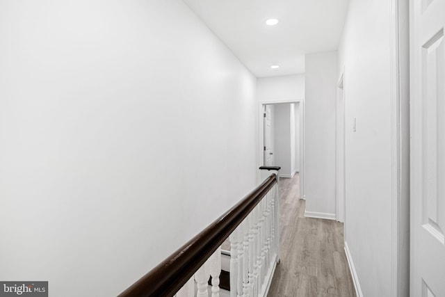 hallway with light hardwood / wood-style floors