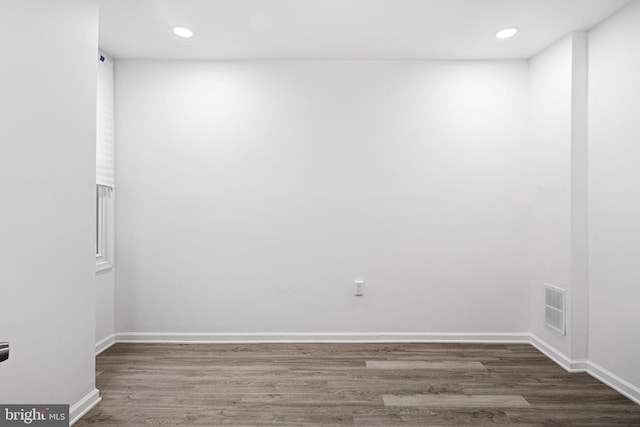 empty room with dark hardwood / wood-style flooring