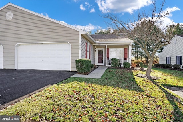 ranch-style home featuring covered porch, a garage, and a front lawn