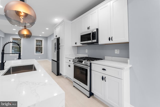 kitchen with white cabinetry, sink, and stainless steel appliances