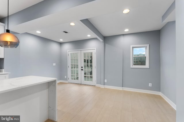 interior space with light wood-type flooring and french doors