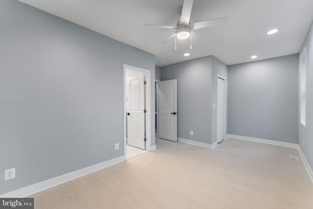 unfurnished bedroom featuring ceiling fan, light hardwood / wood-style floors, and a closet