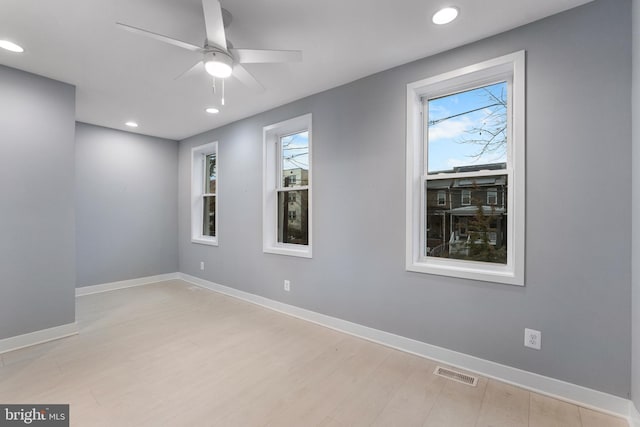 spare room with light hardwood / wood-style floors and ceiling fan