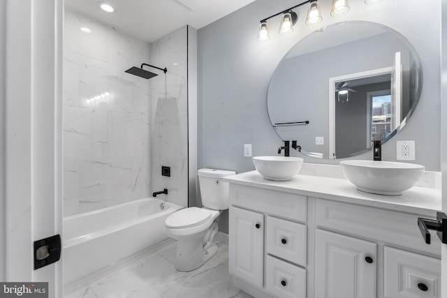 full bathroom with vanity, tiled shower / bath combo, and toilet