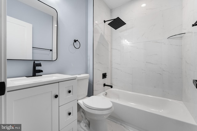 full bathroom featuring vanity, toilet, and tiled shower / bath