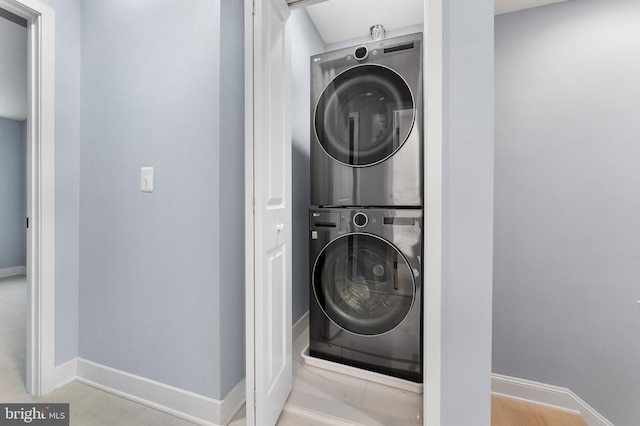 laundry room featuring stacked washer and dryer