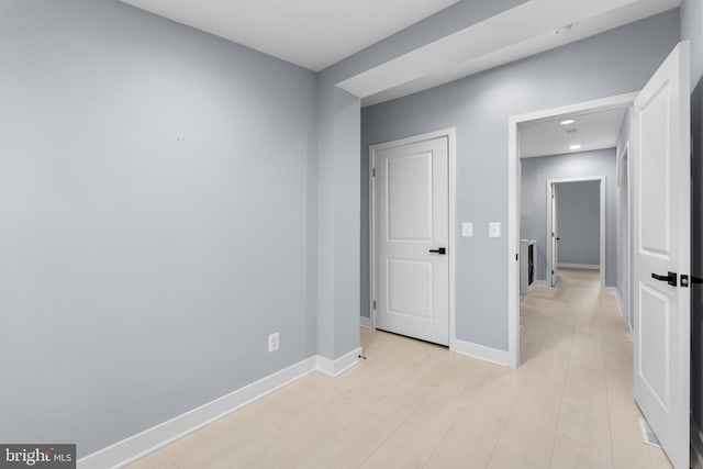 unfurnished room with light wood-type flooring