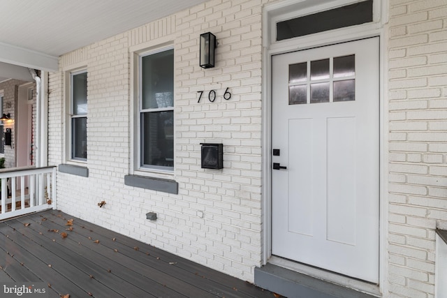 view of exterior entry with covered porch