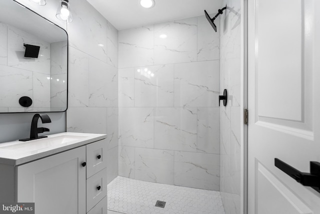 bathroom with vanity and tiled shower