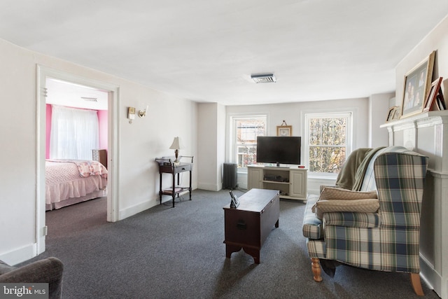 living room with dark colored carpet and radiator