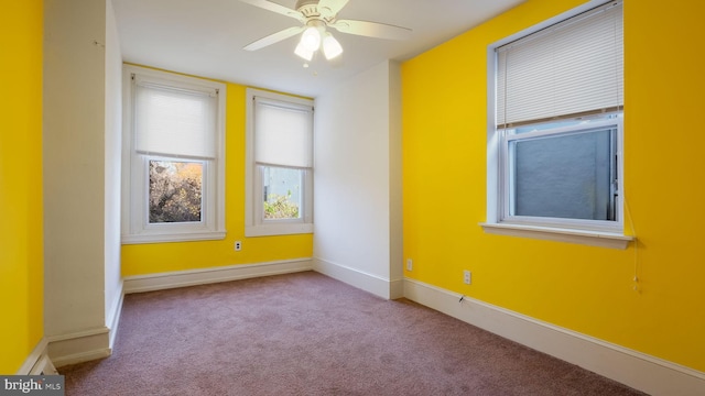 carpeted spare room with ceiling fan