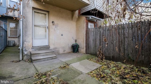 doorway to property featuring central AC unit