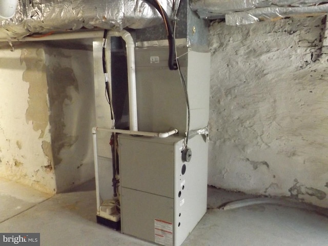 utility room featuring heating unit