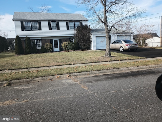 view of front of house with a front yard and a garage