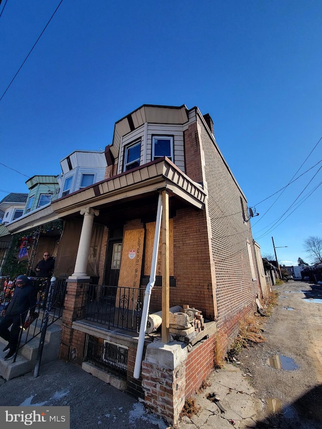 3559 Jasper St, Philadelphia, PA 19134 - view of front of property featuring covered porch, a chimney, and brick siding