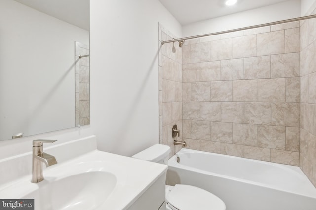 full bathroom with tiled shower / bath combo, toilet, and vanity