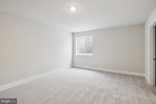 unfurnished room featuring light colored carpet