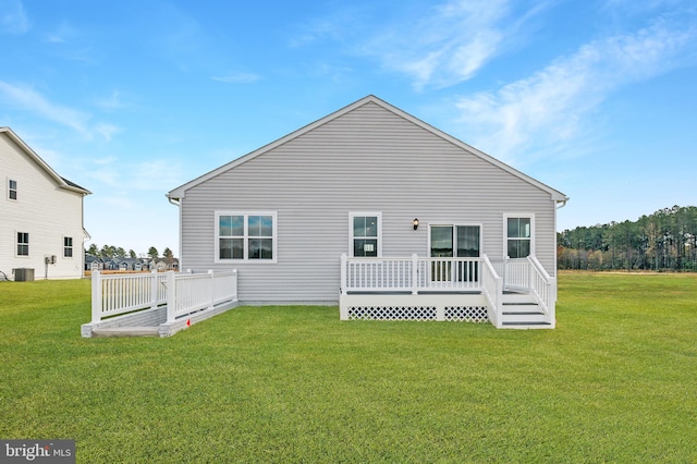 rear view of house featuring a lawn, cooling unit, and a deck