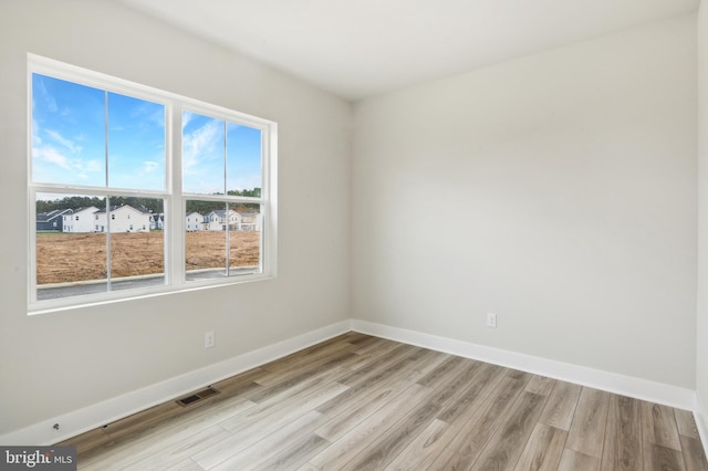 spare room featuring light wood-type flooring