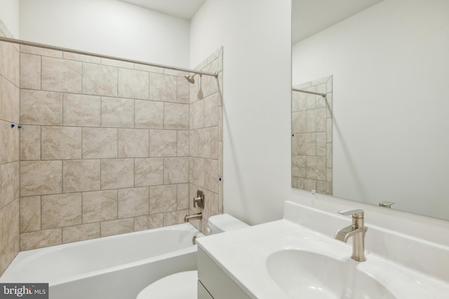 full bathroom featuring vanity, toilet, and tiled shower / bath