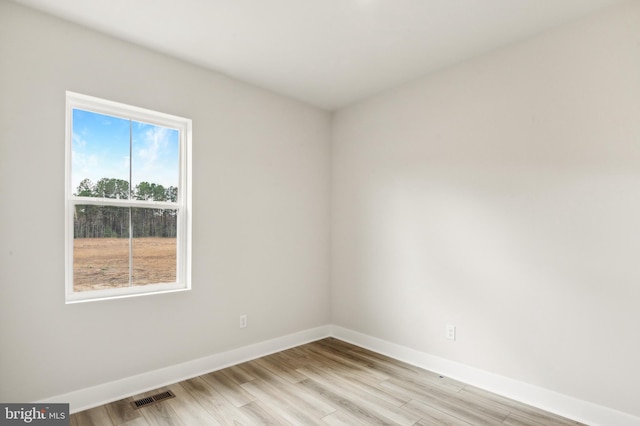 spare room with light hardwood / wood-style floors