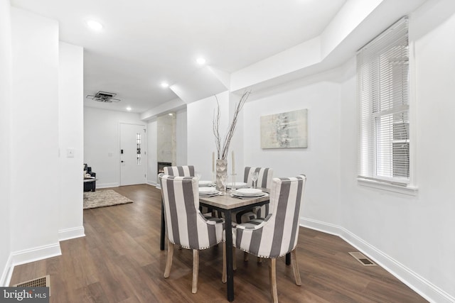 dining area with dark hardwood / wood-style floors