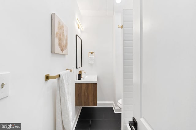 bathroom with tile patterned floors, vanity, and toilet