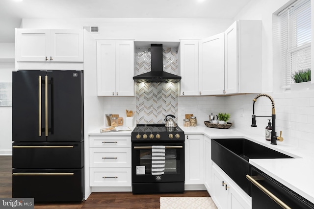 kitchen with premium range hood, backsplash, white cabinets, and black appliances