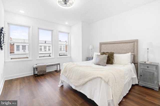 bedroom featuring multiple windows and dark wood-type flooring