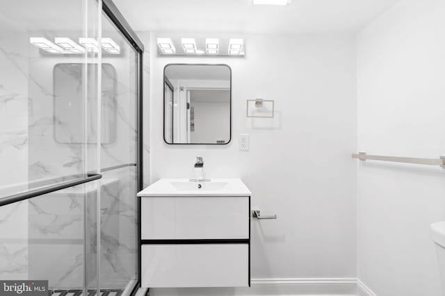 bathroom featuring vanity, toilet, and an enclosed shower