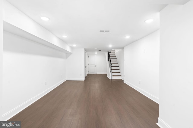 basement featuring dark hardwood / wood-style flooring