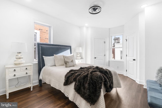 bedroom with dark hardwood / wood-style floors