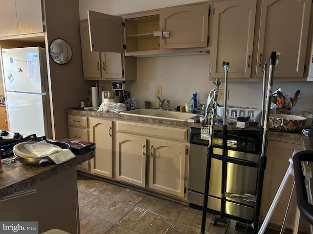 kitchen featuring sink and white fridge