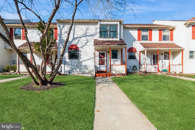 view of property with a front lawn and a porch