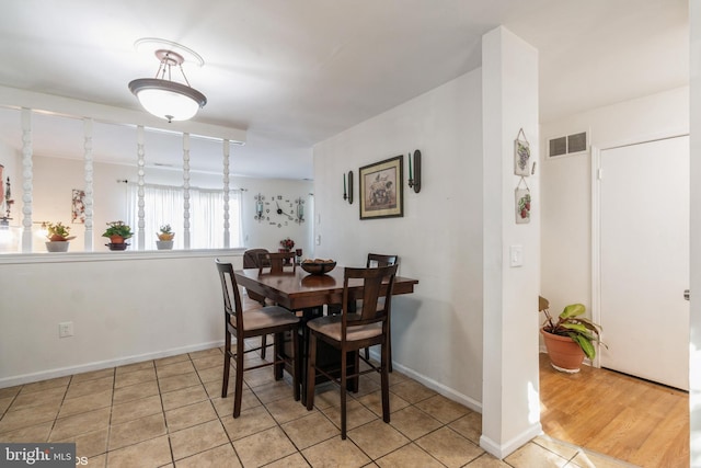 dining area with light tile patterned floors