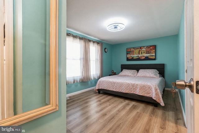 bedroom with wood-type flooring