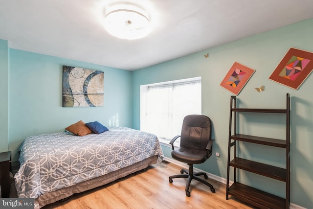 bedroom with hardwood / wood-style flooring